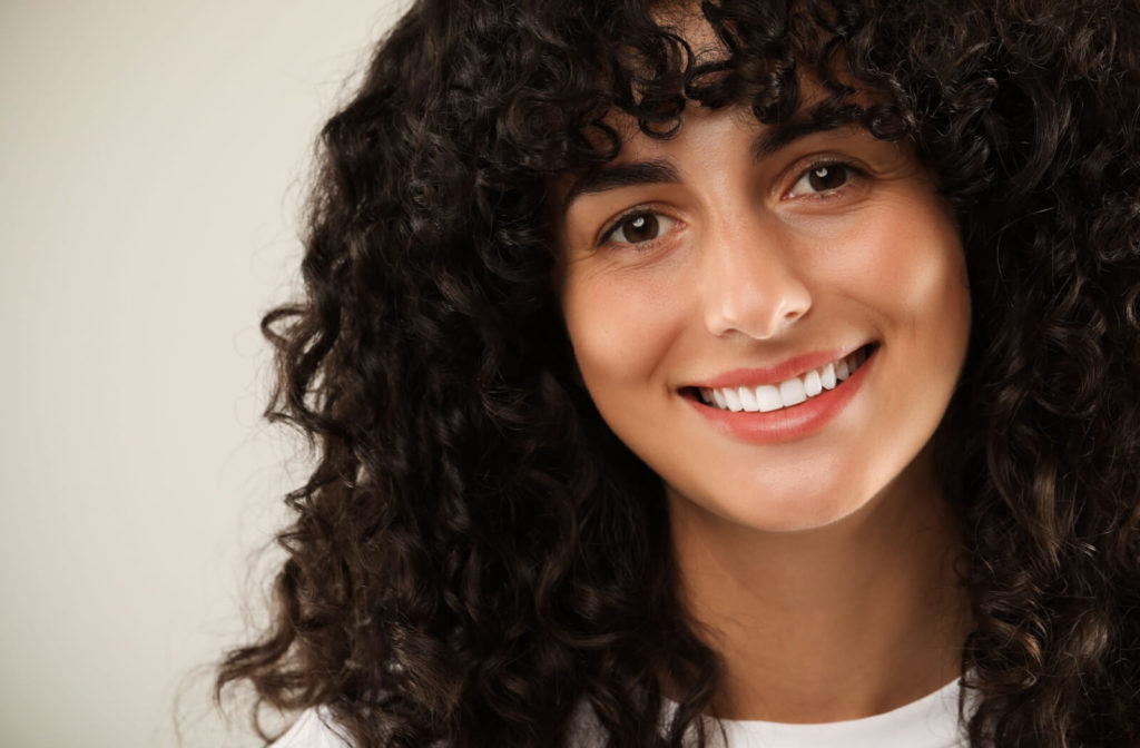 A woman with dental implants smiling